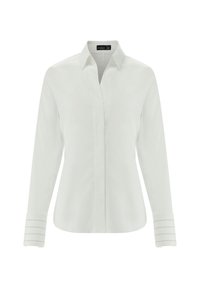 Camicia bianca a maniche lunghe con colletto a punta, pattina frontale e dettagli a righe sui polsini. Realizzata in un tessuto morbido con una silhouette aderente.