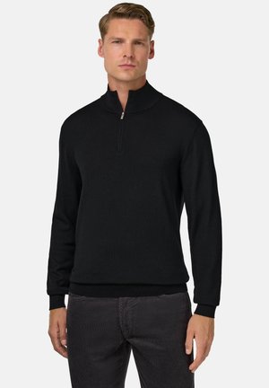 Pullover nero con colletto a zip quarti, maniche lunghe, polsini e fondo a costine, realizzato in un tessuto morbido, progettato per un look aderente.