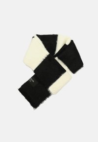 Black and white striped scarf made of soft, fuzzy material. Features a label and distinct color blocks in alternating patterns.