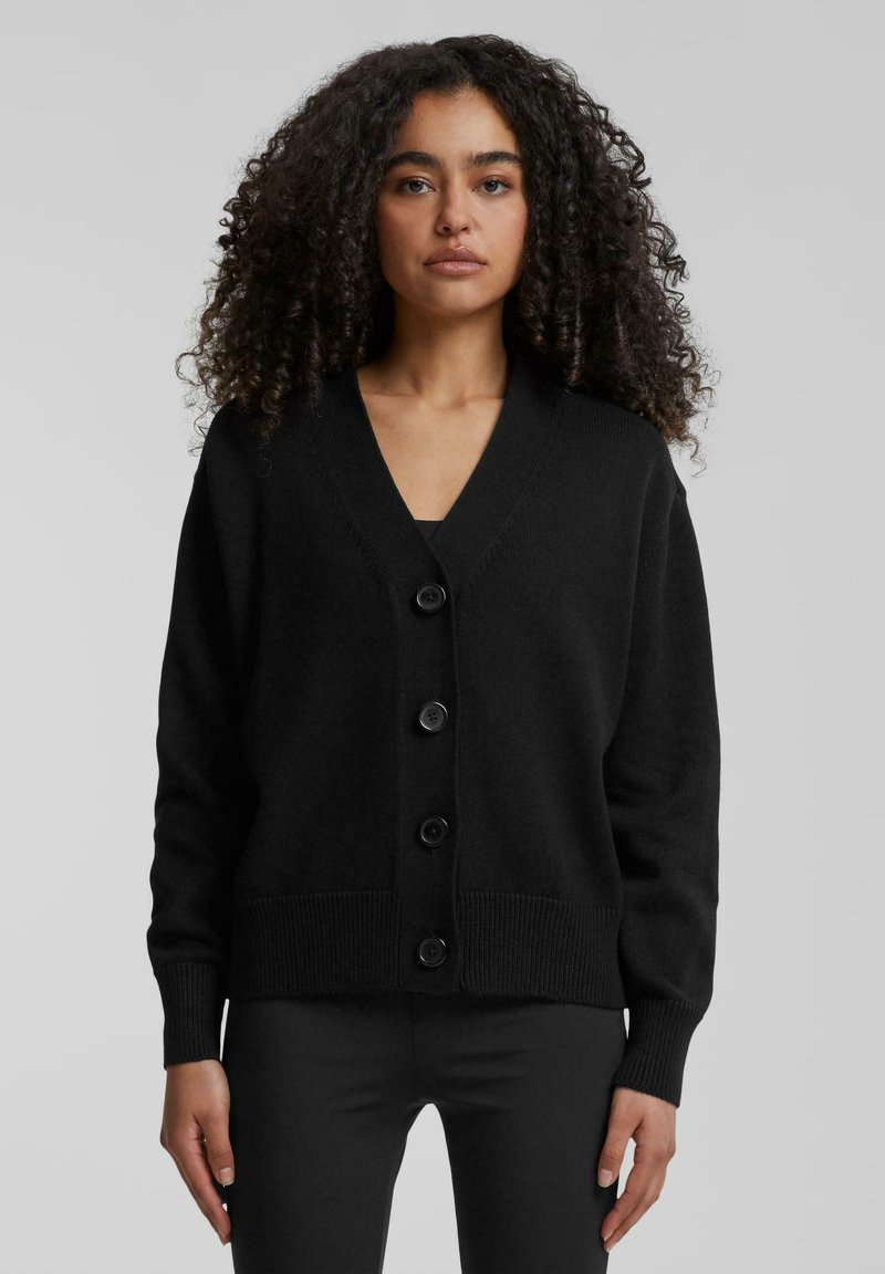 Zwarte cardigan van gebreide stof, met een V-hals, vier knopen aan de voorkant en ribborstels en zoom.