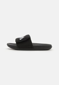 Black slide sandal with a padded strap featuring a white Nike logo. The design includes a textured footbed and rubber outsole.