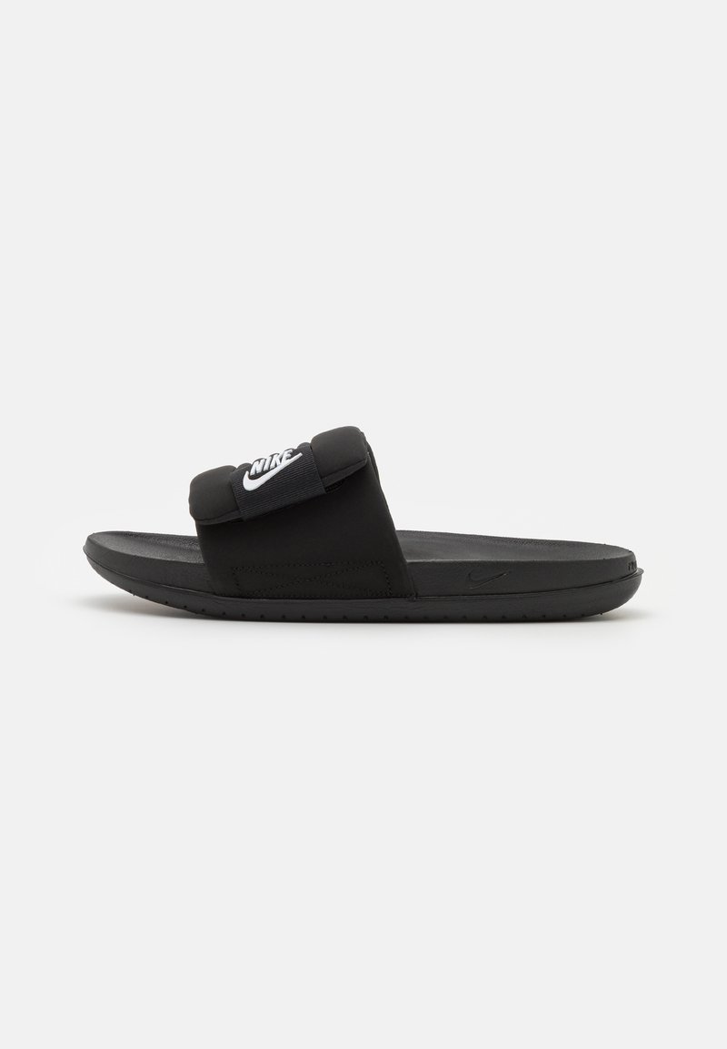 Black slide sandal with a padded strap featuring a white Nike logo. The design includes a textured footbed and rubber outsole.