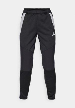 Black athletic pants with a tapered fit, featuring gray side panels, an elastic waistband, and an Adidas logo on the left thigh.