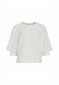 Haut blanc texturé avec des manches ballons trois quarts et un col rond. Dispose d'un motif de surface doux et duveteux ainsi qu'une fermeture zip au dos.