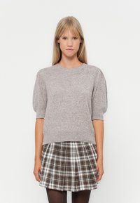 Gray knitted short-sleeve sweater with puff sleeves, featuring pearl-like accents along the bottom, worn over a plaid pleated skirt.