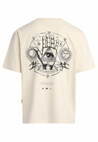 Light beige short-sleeve t-shirt featuring a black graphic design with an eye, sun, and hand motifs, and text underneath the illustration.