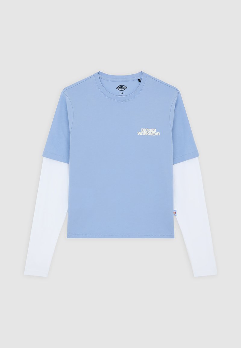 Light blue short-sleeve shirt layered over a white long-sleeve shirt, featuring a subtle logo design on the chest. Cotton texture.
