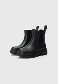 Black rubber ankle boots with side elastic panels, textured soles, rounded toes, and rear pull tabs for easy wear.