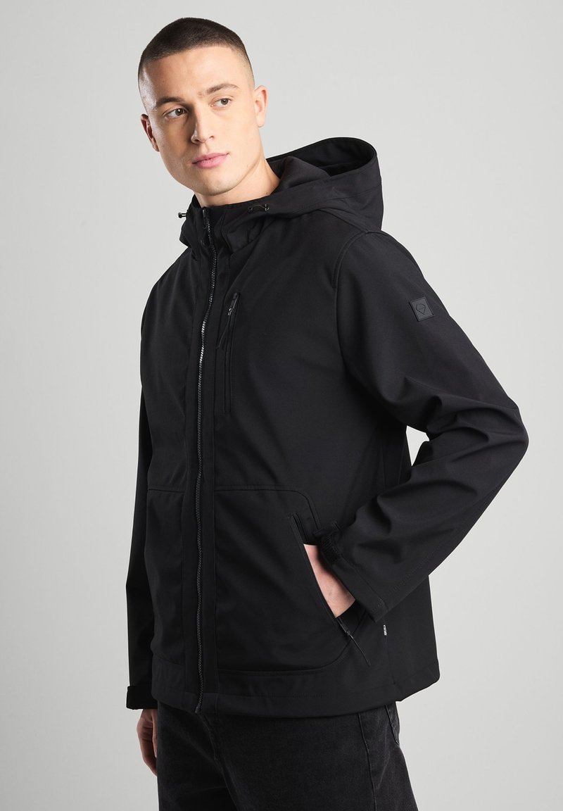 Black weather-resistant jacket with a hood, zippered front, chest pocket, and side pockets. Smooth texture and sleek design.
