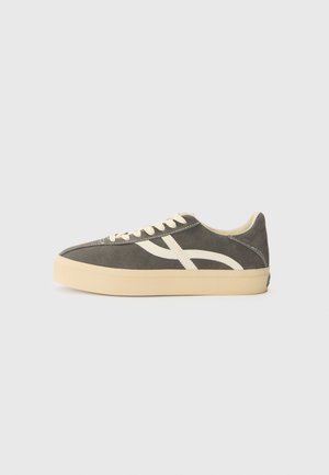 Gray suede sneakers with cream accents, round toe, flat laces, and a thick rubber sole. Features a diagonal design element on the side.