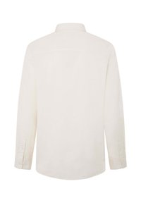 Camisa de manga larga y botones en tejido color crema con una textura suave. Presenta un cuello y dobladillo redondeado. Incluye puños con botones.