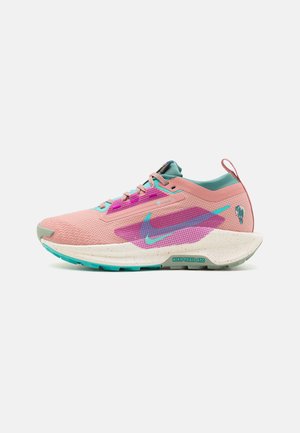 Nike Trail ATC running shoes feature a pink textile upper with aqua and purple accents, a chunky white speckled sole, and a reinforced heel tab.