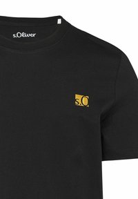 Black cotton t-shirt featuring a round neckline and short sleeves. A small yellow s.Oliver logo is positioned on the left chest.