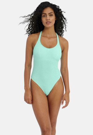 Maillot de bain une pièce vert menthe en tissu texturé, avec des jambes hautes et un col rond, doté de fines bretelles croisées dans le dos.