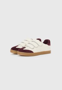 White leather sneakers with maroon suede accents, featuring three Velcro straps, perforated details, and a gum rubber sole.