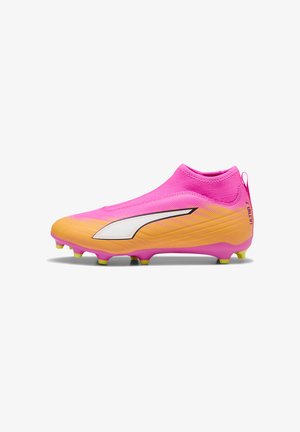 Bota de fútbol en rosa y naranja con logo blanco, cuello de tobillo tipo calcetín y tacos amarillos en la suela, mostrada de perfil.