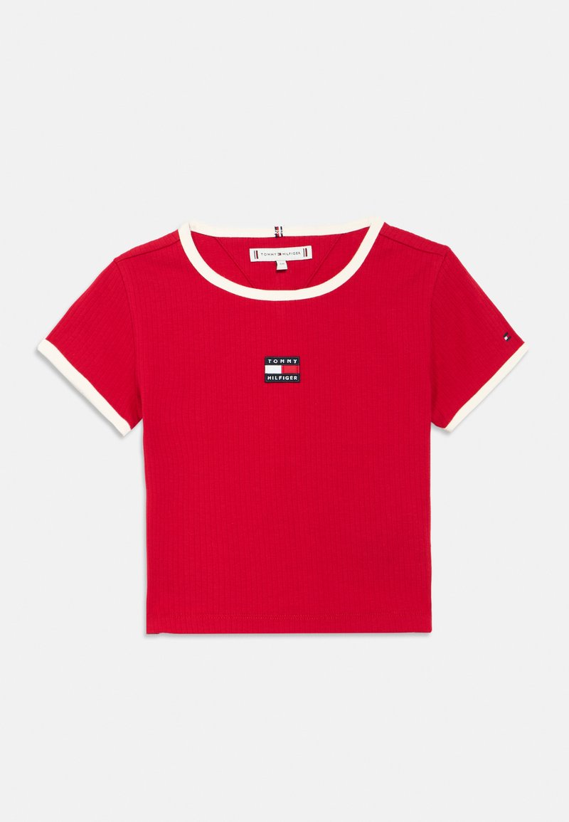 Red ribbed short-sleeve T-shirt featuring a contrasting white crew neck and sleeve cuffs, with a small black logo patch on the chest.
