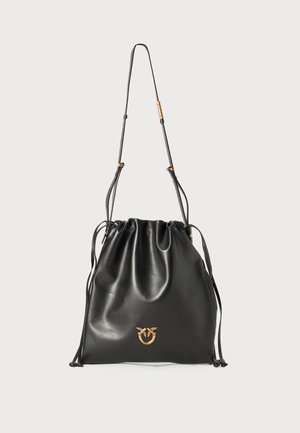 Black leather drawstring bag with a glossy finish, slim shoulder strap, and gold-tone logo detail at the front.