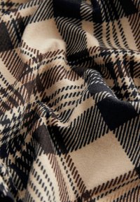 Beige fabric with a checkered pattern in brown and navy, featuring varied line weights and textures, creating depth and visual interest.