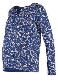 Haut bleu à manches longues avec motif géométrique et de vigne blanc, col rond et coupe décontractée.