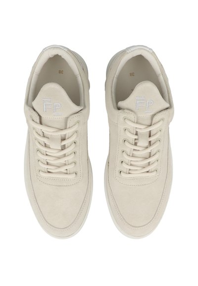 Beige suede sneakers with flat laces, padded tongue, and embossed logo. Rounded toe and textured white rubber sole. Minimalist design.