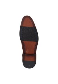 Suela de zapato con un tacón de goma oscura, mediopie de color marrón texturizado con un patrón enrejado y una sección negra lisa en la punta. Detalle de costura azul.