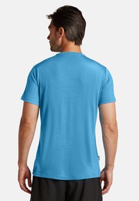 Short-sleeve t-shirt in bright blue fabric, featuring a crew neckline and a straight hem, with a smooth texture and no visible patterns.