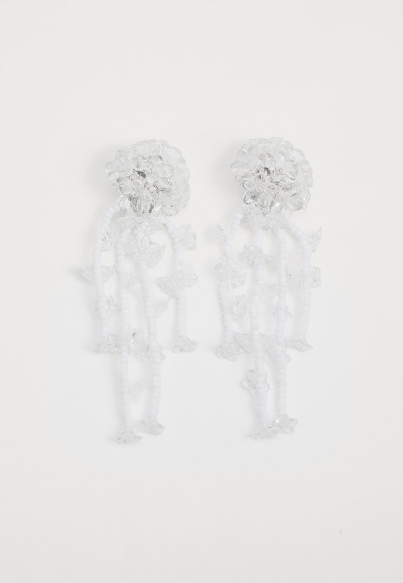 Clear flower-shaped earrings with dangling beaded strands; features transparent and white accents, showcasing intricate floral details.
