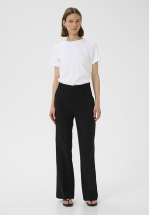 White short-sleeve t-shirt paired with high-waisted black wide-leg trousers. Simple design, smooth texture, and minimal detailing.
