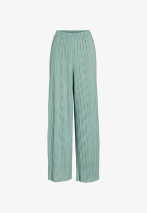 Pantalon ample vert clair avec des plis verticaux et une taille élastique, présenté sur un fond blanc.