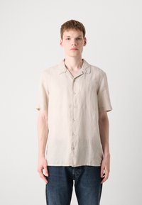 Short-sleeved beige button-up shirt made of lightweight fabric with a relaxed fit. Features a classic collar and subtle texture.