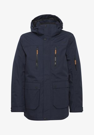 Veste imperméable bleu marine avec capuche, dotée de deux poches zippées supérieures, de deux poches à rabat inférieures et de accents en cuir beige sur les fermetures éclair.