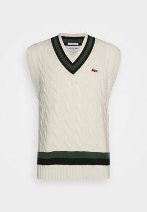 Cable-knit, sleeveless white sweater vest with a V-neck, featuring green and black striped trim and a small red logo on the left chest.