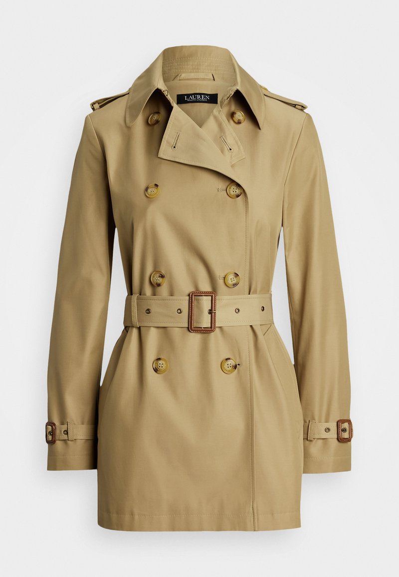 Beige trench coat with double-breasted design, large buttons, belted waist, and epaulets on shoulders. Smooth fabric with a classic silhouette.