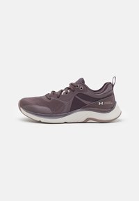 Purple athletic shoe with a mesh upper, cushioned sole, and textured accents. Features laces and a pull tab at the heel.