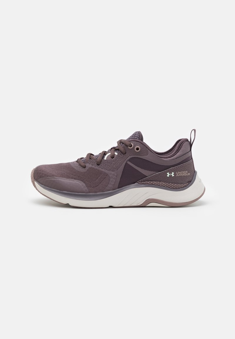 Purple athletic shoe with a mesh upper, cushioned sole, and textured accents. Features laces and a pull tab at the heel.