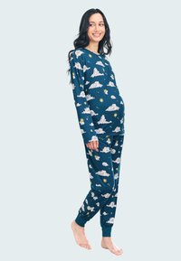 Maternity pajama set in dark blue fabric features white clouds and yellow stars pattern. Long sleeves and elastic cuffed pants finish the look.