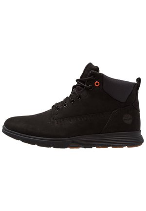Black high-top boot with lace-up front, padded collar, rubber sole, and subtle embossed tree logo on the heel side.