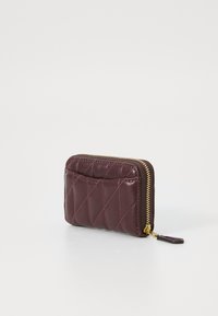 Burgundy leather wallet with a quilted pattern, gold zipper, and an exterior card slot, compact rectangular shape. Textured finish.