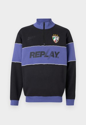Black and purple half-zip sweatshirt with "REPLAY" logo across chest and Replay FC crest with three stars on upper left.