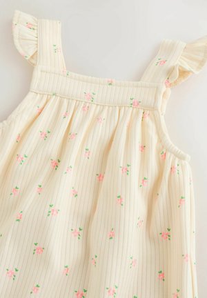 Abito senza maniche color crema con righe verticali e motivo floreale in rosa e verde. Spalline arricciate aggiungono un dettaglio elegante.