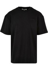 Schwarzes kurzärmeliges T-Shirt aus Baumwolle mit Rundhalsausschnitt und dezentem Logo auf der Brust. Glatte Textur, lockere Passform.