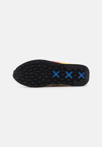 Shoe sole with a textured black rubber base. Features hexagonal patterns and three blue cross accents. Flat design for stability.