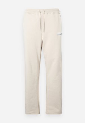Beige sweatpants made of soft material, featuring an elastic waistband with drawstring, straight legs, and small blue logo detail.