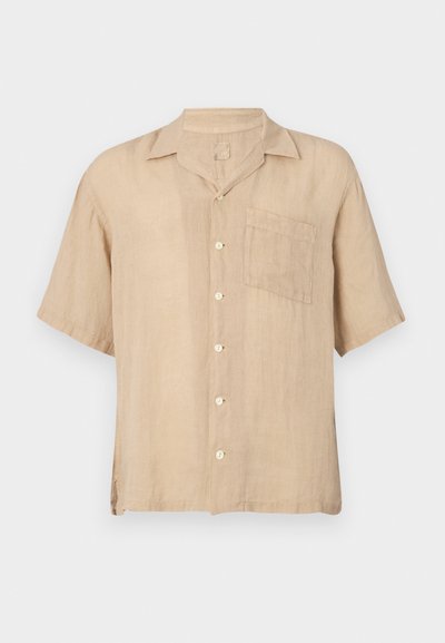 Short-sleeve beige linen shirt with a notch collar, front pocket, and white buttons. Textured fabric, relaxed fit, and straight hem.