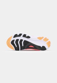 Shoe sole featuring a black and white design with orange and red accents. Textured rubber for grip and durability in a rounded shape.