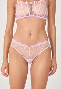 Durchsichtiges rosa Dessous-Set mit floralen Stickereien, Spitzenverzierungen und geformten Cups. Netzstoff sorgt für Textur und Detail.