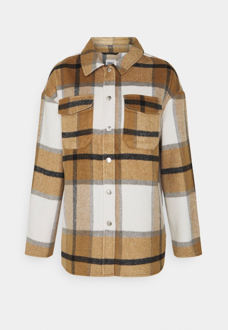 Brun- och vitrutig flanellskjortjacka med två bröstfickor, knappstängning och en klassisk krage. Mjuk textur, oversized passform.