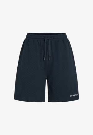 Shorts azul marino texturizados con cintura elástica y cordón. Presenta un pequeño logo blanco en la parte inferior de la pierna derecha.