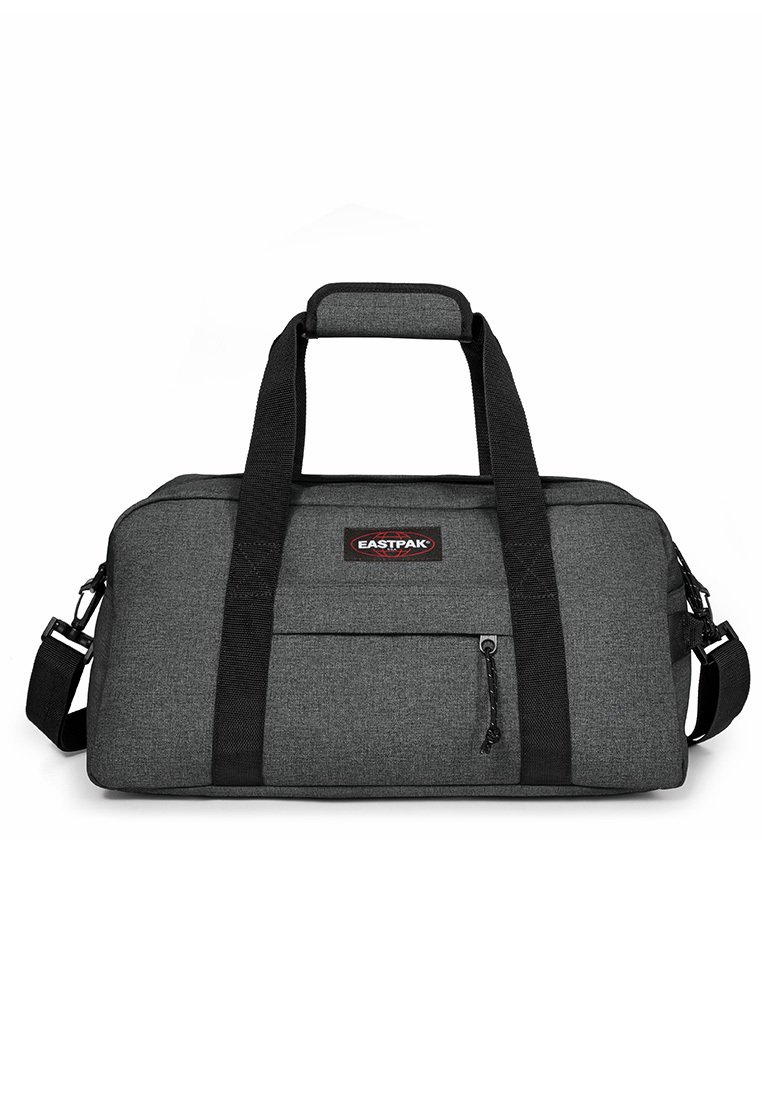 Gray fabric duffel bag with black straps, a front zip pocket, and a padded handle. Features logo patch on the front. Compact rectangular shape.